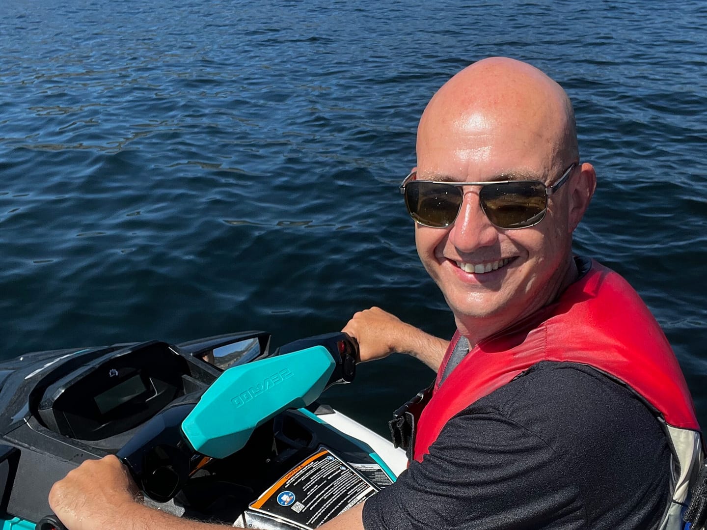 Markus smiling while riding a seadoo