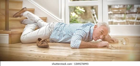 picture of an elderly man on the ground at the bottom of the stairs