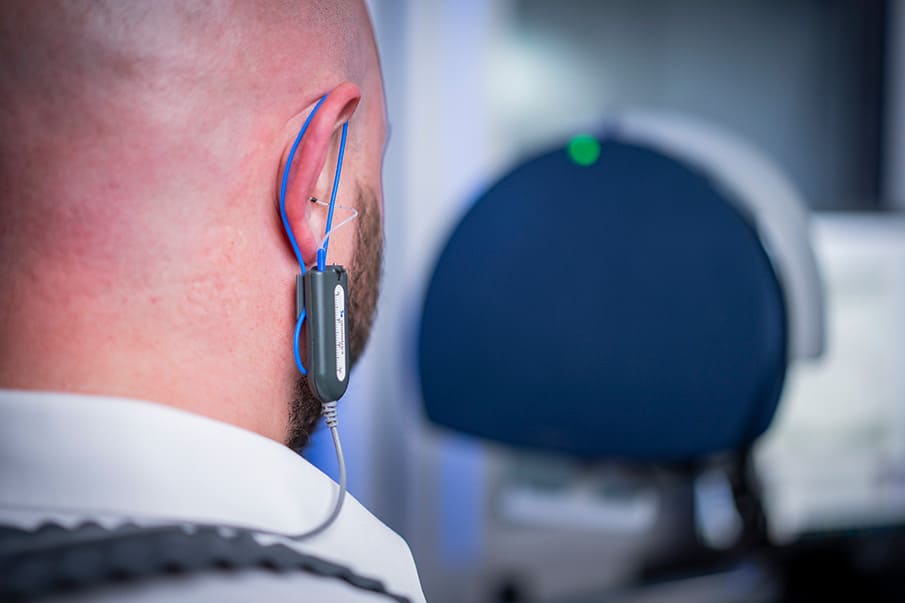 image of the back of an ear with REM hookups in place